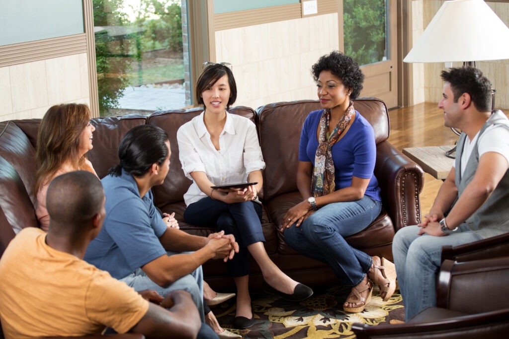 Group of people having group therapy